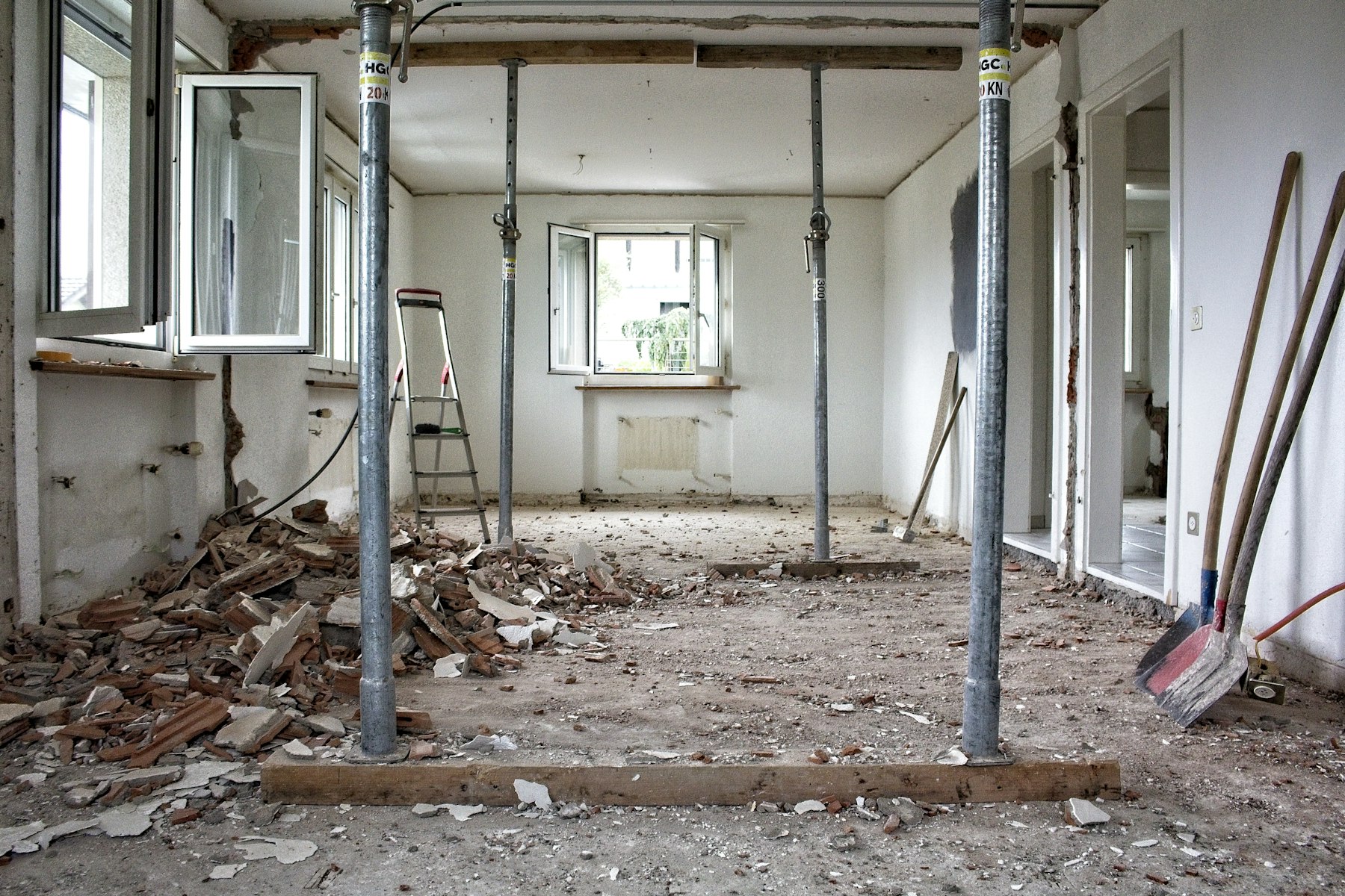An interior mid strip-out, with temporary steel supports and swept debris