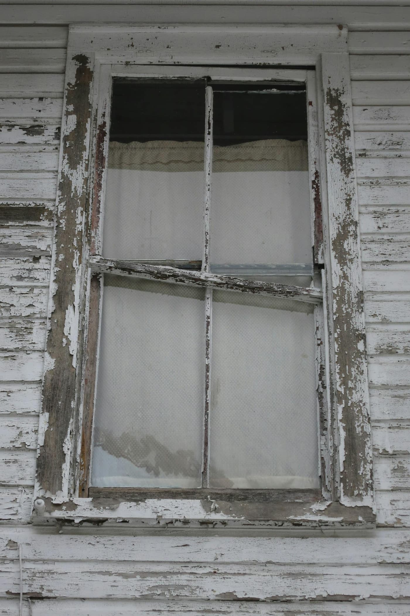 An old painted window frame with flaking paint