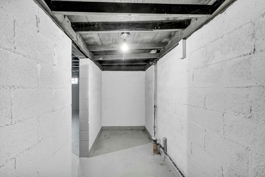 A clean, freshly painted basement corridor with block walls