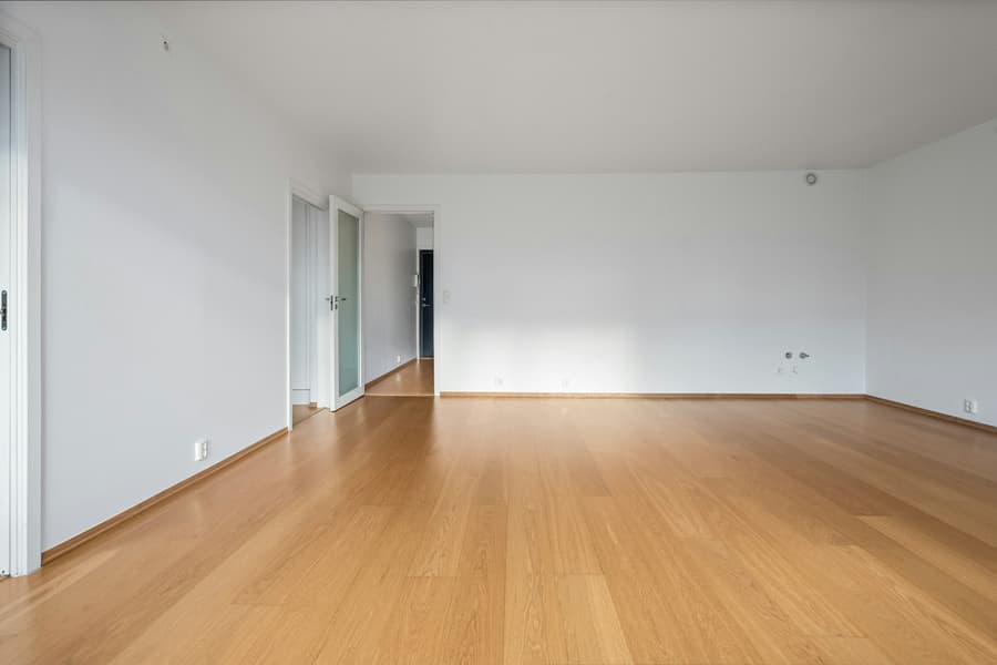 A bright, empty room with wood floors, ready to be handed back